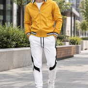 Yellow jacket and white pants with black accents on a white background