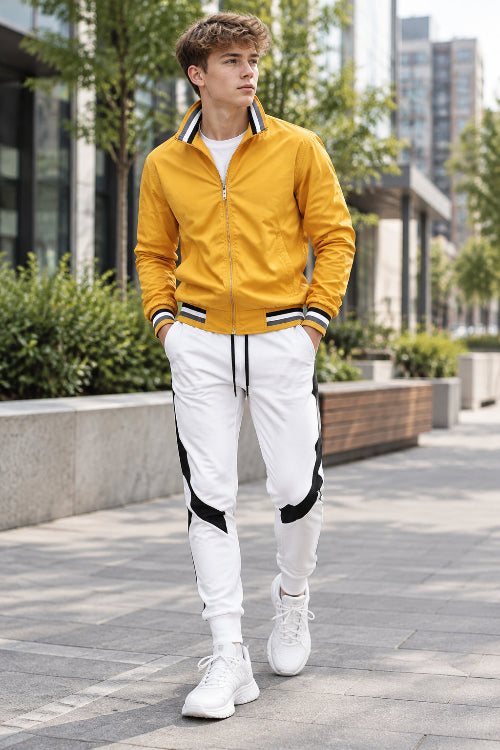 Yellow jacket and white pants with black accents on a white background