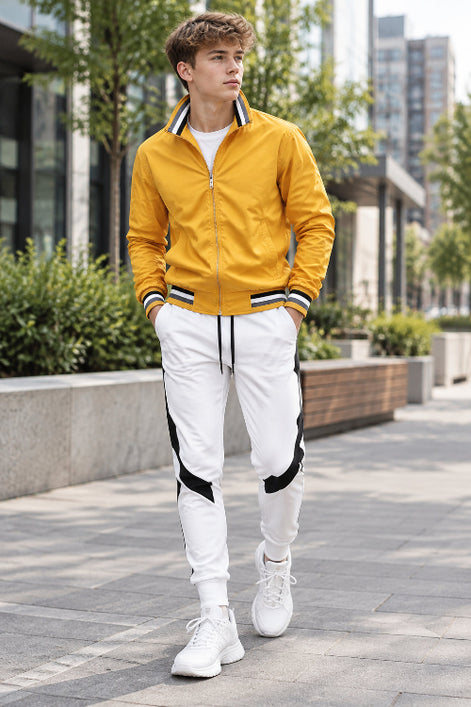 Yellow jacket and white pants with black accents on a white background