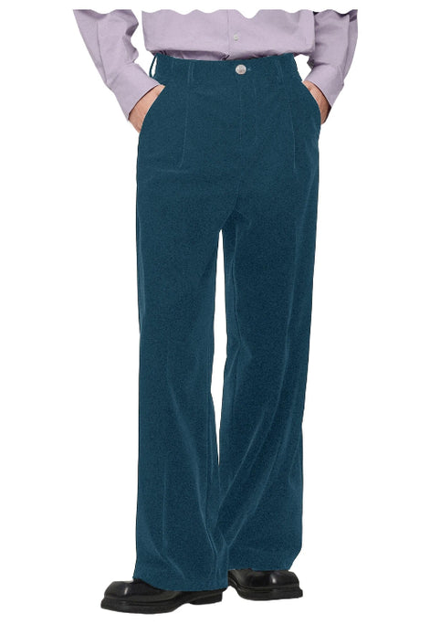 A person wearing high-waisted, wide-leg green corduroy trousers, styled with a light lavender ruffled shirt and black leather shoes,