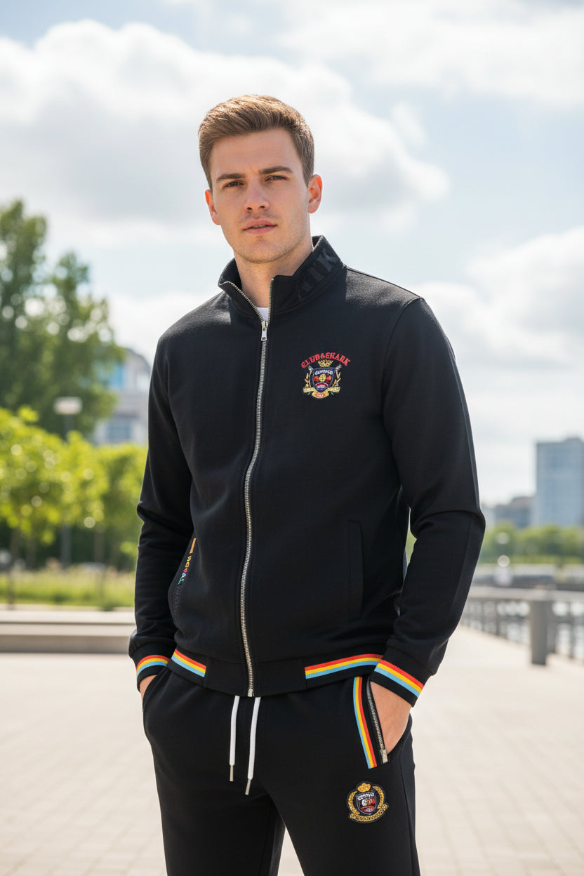 A two-piece navy blue tracksuit set featuring a zip-up jacket and matching pants. The jacket and pants have red, yellow, and white striped accents at the cuffs, hem, and waistband.