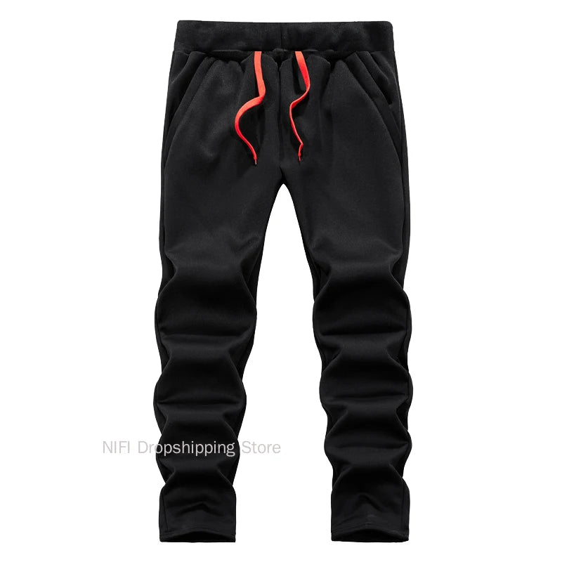 Black jogger pants with red drawstring on a white background
