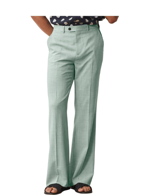 Green pants worn by a person on a white background