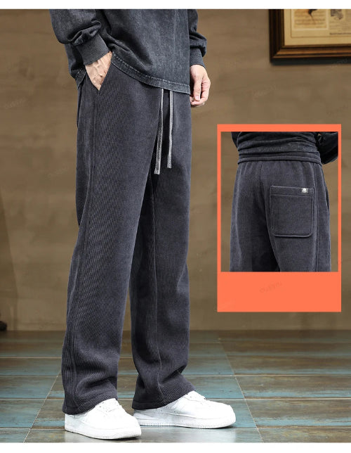 Person wearing dark gray sweatpants with a close-up inset showing a pocket detail.