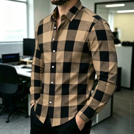 A man wearing a long-sleeve button-up shirt with a large brown and black buffalo check pattern, standing in an office environment.