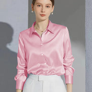 Pink satin blouse worn by a model, shown from the front.