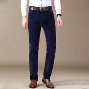 Navy blue pants worn by a person on a beige background