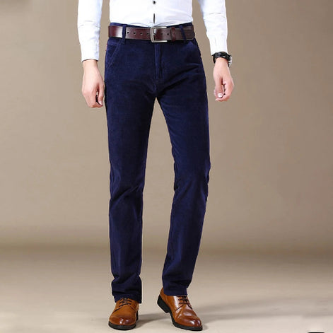 Navy blue pants worn by a person on a beige background