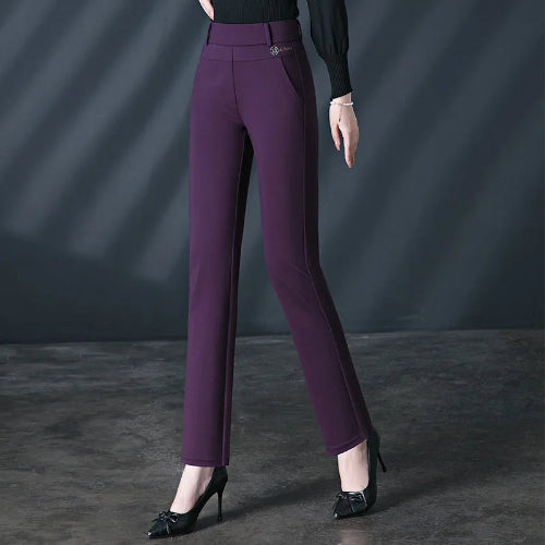 Purple pants worn by a person on a dark background