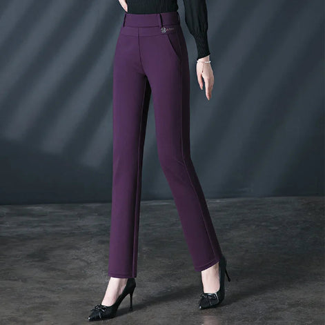 Purple pants worn by a person on a dark background