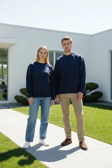 A navy blue crewneck sweatshirt with a small blue embroidered Dior logo on the left chest, displayed flat against a solid white background.