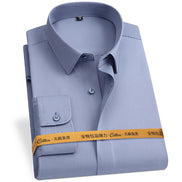 Folded light blue dress shirt with a yellow label on a white background