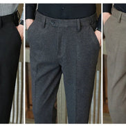 Three side-by-side views of men's dress pants in different colors: black, dark gray, and taupe. Each pair is shown on a model cropped from the waist down, 