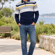 A men's long-sleeve polo shirt with a color-blocked stripe pattern in navy blue, white, gray, and yellow, shown on a plain white background.
