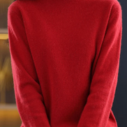 A close-up of a woman wearing a bright red, long-sleeve turtleneck sweater. The sweater is shown on a mannequin or model cropped from the nose down, 