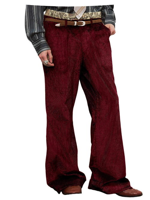 A pair of men's wide-leg corduroy trousers in a deep burgundy red, styled with a brown leather belt and a patterned shirt, shown on a white background.