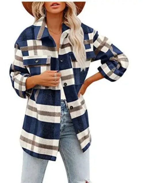 Woman wearing a navy and cream plaid shirt with jeans, against a white background.