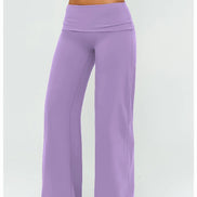 Purple yoga pants worn by a person on a white background