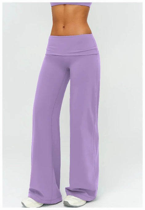 Purple yoga pants worn by a person on a white background