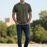 Green t-shirt with a brown patch on a hanger