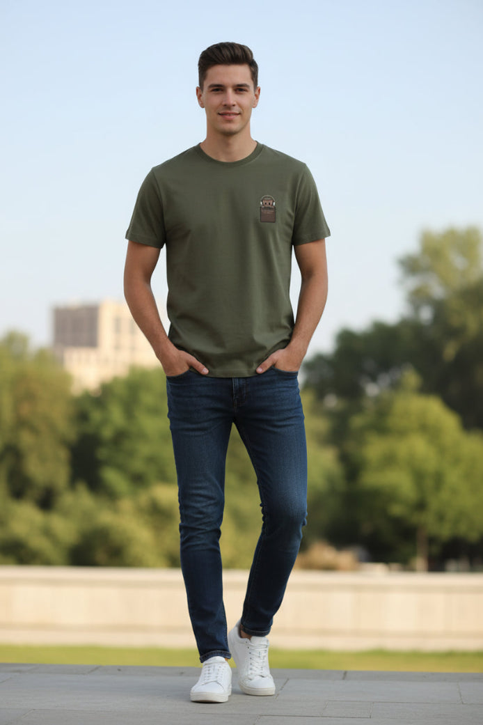 Green t-shirt with a brown patch on a hanger