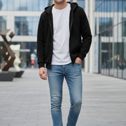 Black hoodie with a zipper on a light gray background