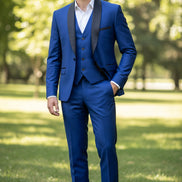 Man wearing a blue suit with black lapels on a gray background