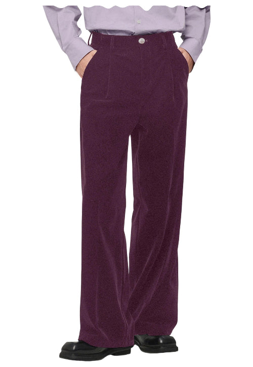 A person wearing high-waisted, wide-leg corduroy trousers in a deep plum purple, styled with a light lavender 