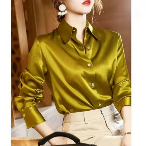 Mustard yellow satin button-down shirt worn by a model with beige pants.