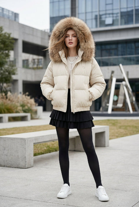 A beige puffer jacket with a large brown faux-fur trimmed hood, displayed on a mannequin in a boutique setting.