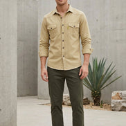 Beige button-up shirt with two front pockets on a white background