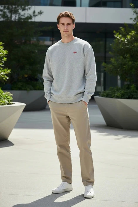 Gray sweatshirt with a small red logo on a white background