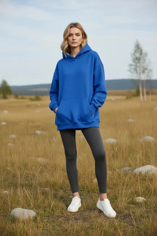 Person wearing a bright blue hoodie on a white background