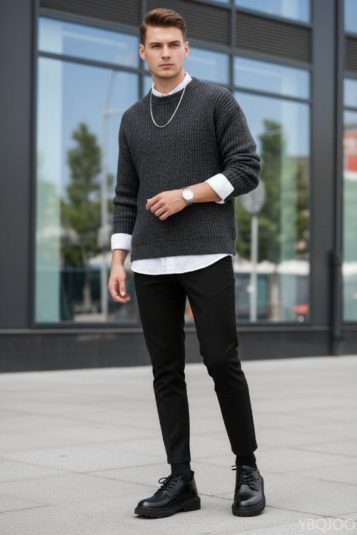 Black leather shoes worn with black pants on a white surface.