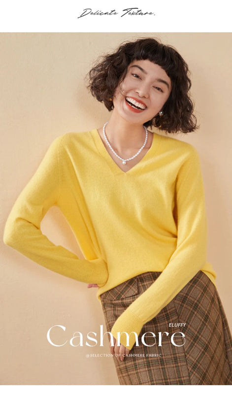 Woman wearing a yellow cashmere sweater with a beige background