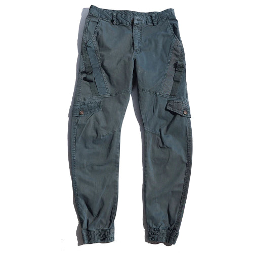 Gray cargo pants laid flat against a white background, showing angled thigh pockets, buttoned flap pockets, side straps, and gathered ankle cuffs.