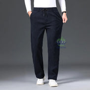 Person wearing dark blue pants with a gray background
