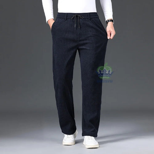 Person wearing dark blue pants with a gray background