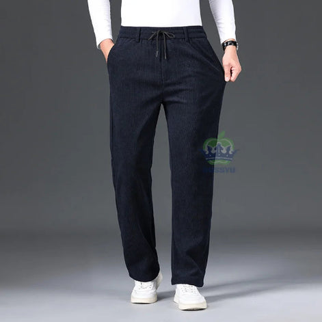 Person wearing dark blue pants with a gray background