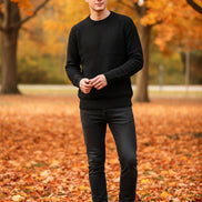 Black turtleneck sweater with a 'warm' label on a hanger