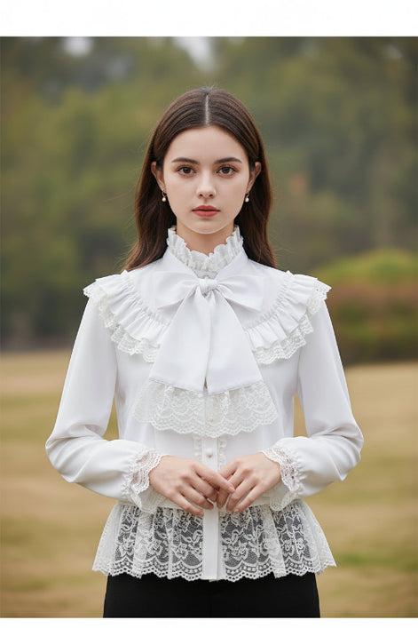 White blouse with lace details and a large bow on a mannequin against a gray background