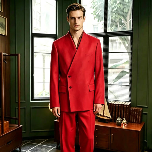 A man wearing a bright red double-breasted suit with a unique wrap-style collar, standing in a vintage room with dark green paneled walls and large windows.