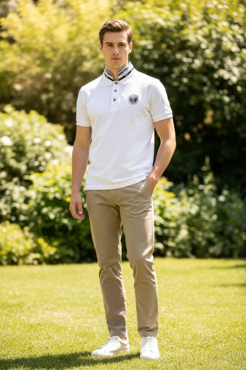 White polo shirt with a designer emblem on a mannequin against a gray background