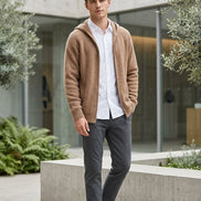 Brown hoodie on a wooden hanger against a white background