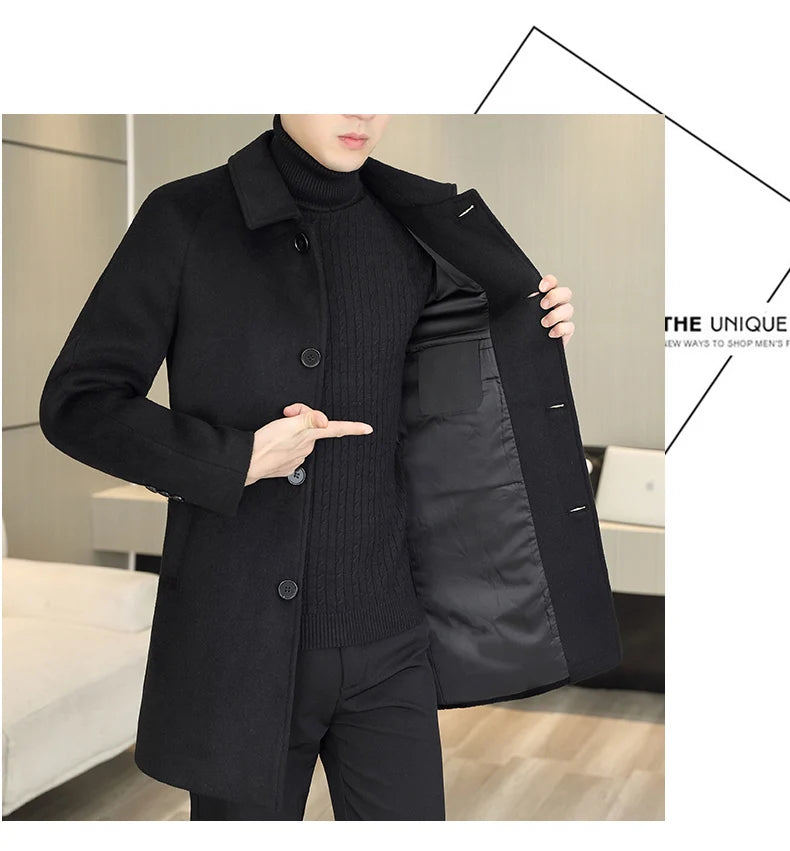 A man wearing a black mid-length coat over a black ribbed turtleneck sweater and black pants, holding the coat open to show the padded black interior. The photo is cropped from the lower face to the upper thighs, with a light indoor room background and a small graphic design element in the top-right corner.