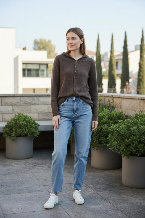Person wearing a brown cardigan in a clothing store setting