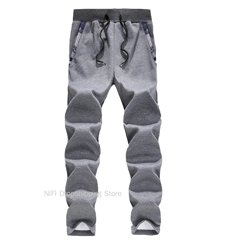 Gray jogger pants with patchwork design on a white background