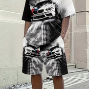 A person wearing a matching black and white graphic t-shirt and shorts set featuring a dramatic racing car print