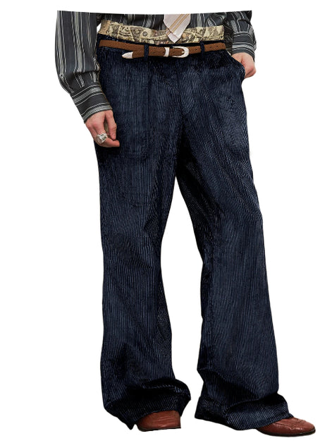 A person wearing dark blue pinstriped trousers with a brown belt, a patterned shirt, and brown shoes, shown from the waist down on a white background.