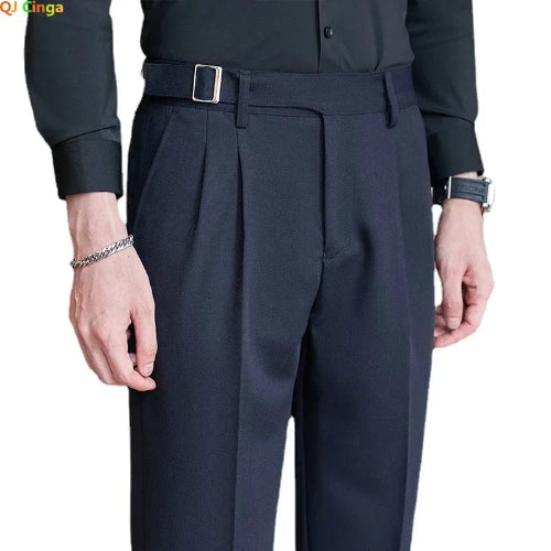 Dark gray pleated pants worn by a person on a white background